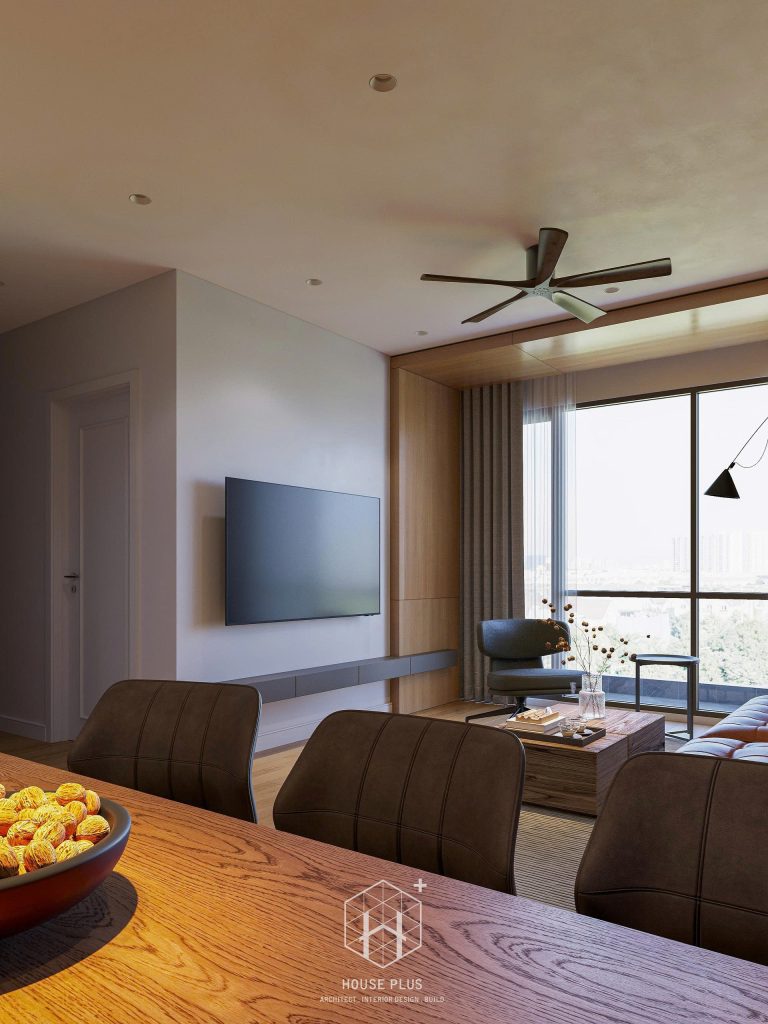 Phòng khách căn hộ chung cư nhìn ra ban công với sofa nâu và kệ tivi treo tường